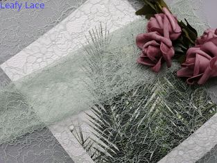 100%のポリエステルによって束ねられたレースの生地は色の刺繍された生地をカスタマイズした