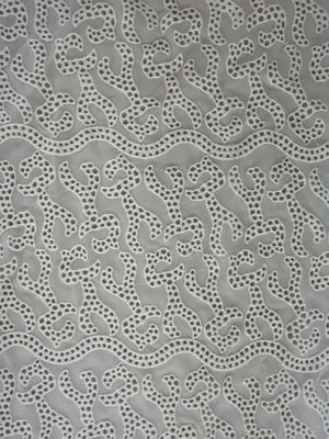 アイボリーの刺繍されたアイレット生地